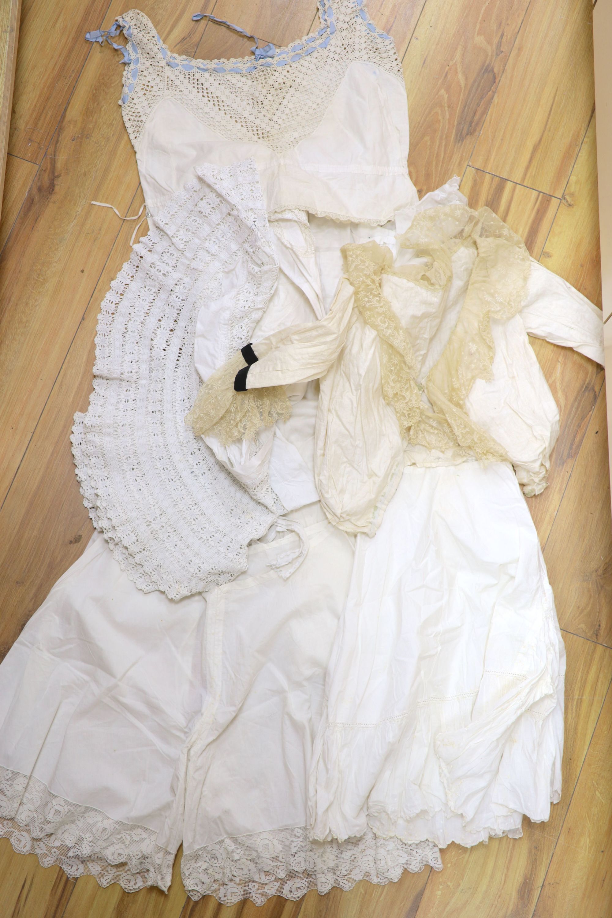 A collection of Victorian white worked camisoles, petticoats and underwear